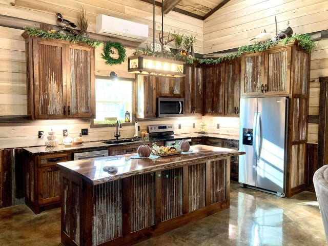 A photograph of a cozy kitchen with a rustic and weathered appearance, featuring elements of rust and worn textures. 