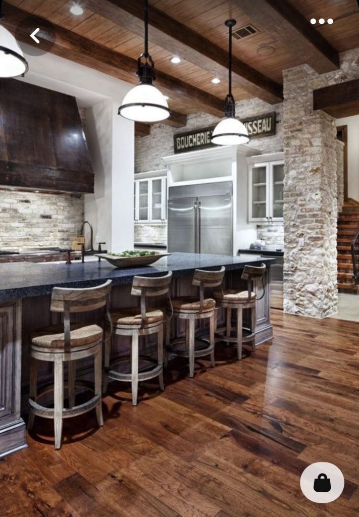  A photograph of a kitchen with exposed wooden beams, adding a natural and rustic element to the space. 