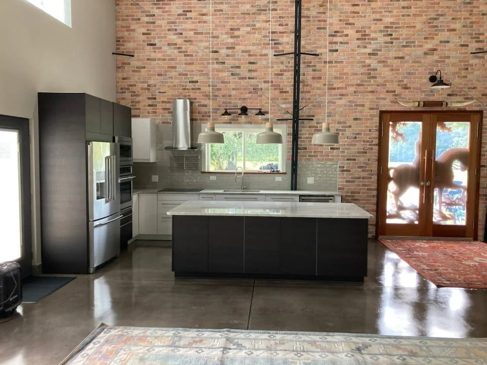 An image of a stunning minimalist and modern kitchen with a sleek design. The space features clean lines, geometric shapes, and a monochromatic color palette that creates a sense of calm and order.