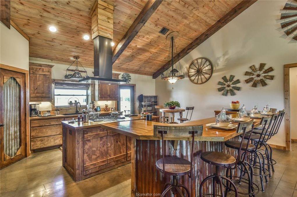 An image of a sleek and modern wooden kitchen bar. The bar features a minimalist design with clean lines and a warm wood finish that creates a welcoming and cozy atmosphere. The countertop is made of a durable and easy-to-clean material, such as quartz or granite, providing a practical and functional surface for food preparation and dining