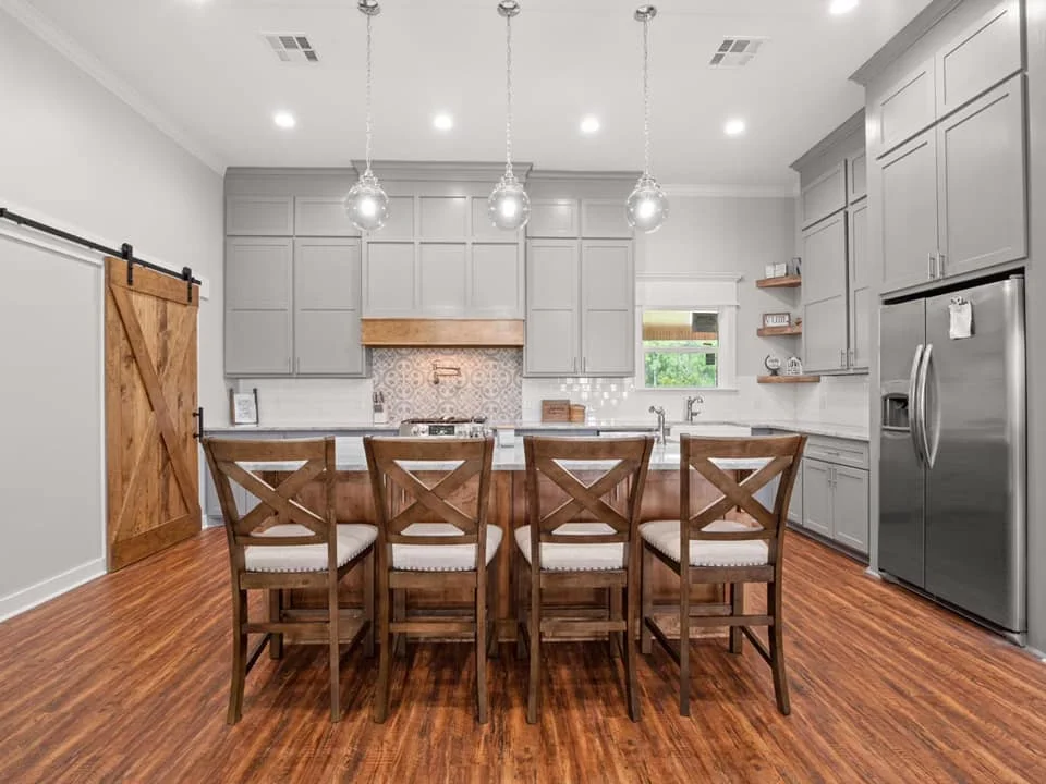 A photograph of a kitchen with a minimal color scheme, creating a sleek and modern look.