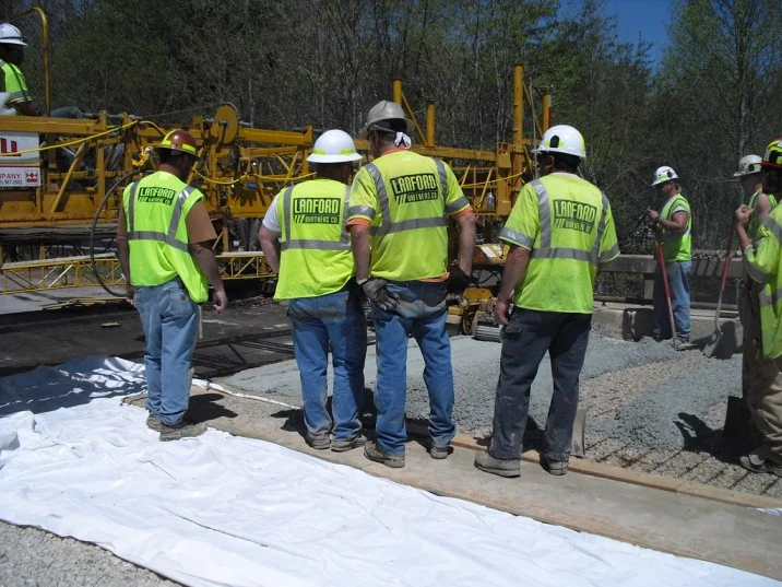 A goup of contractor pouring concrete