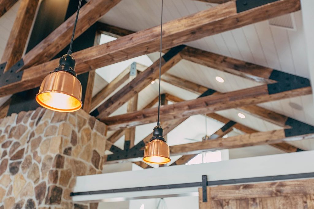 An image of an exposed wood beam ceiling with a warm and inviting ambiance. 