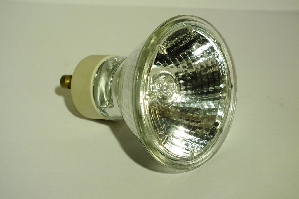  a halogen lamp, quartz-halogen, or quartz iodine lamp on top of a smooth surface