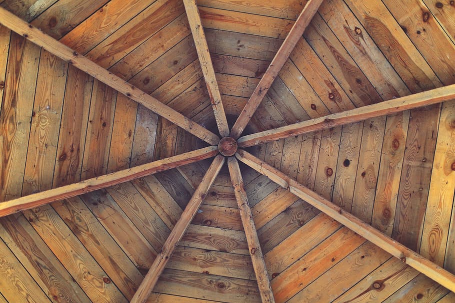 An image of a wood planked ceiling with a warm and rustic feel. 