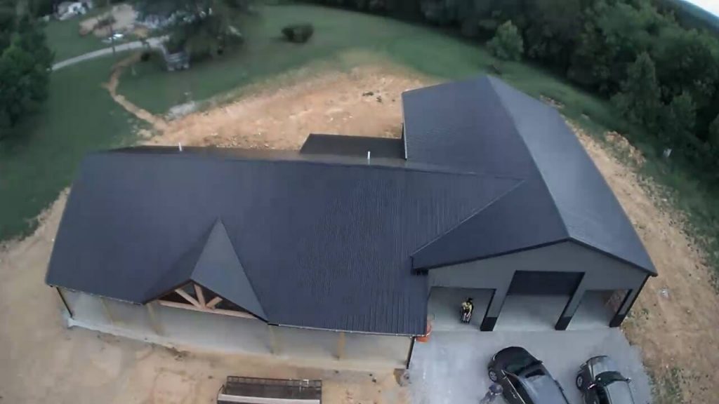 A house with a gable roof style featuring two sloping sides that meet at the top forming a triangular shape.