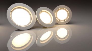 led light bulbs that are lit up and placed in a row around a dark room