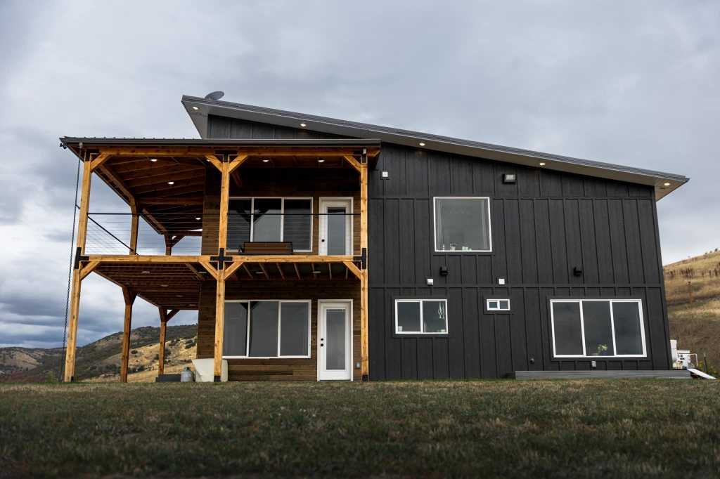 The image is a close-up view of a small shed with a roof that slopes downward on one side, creating a shed roof style. 