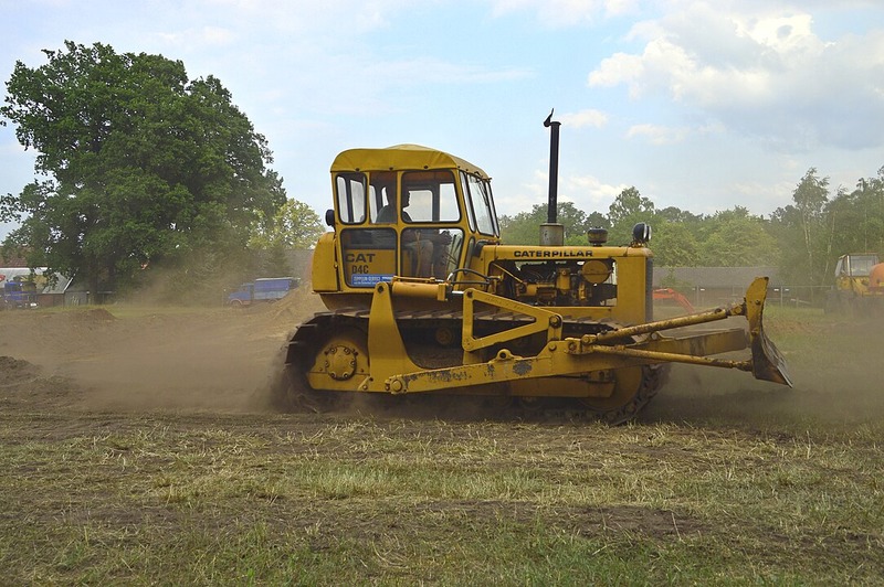 A compact and agile mini bulldozer standing ready on a construction site, highlighting its versatility in tight spa
