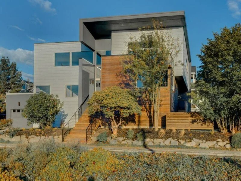 A charming two-story house featuring a harmonious combination of brown and gray tones. 