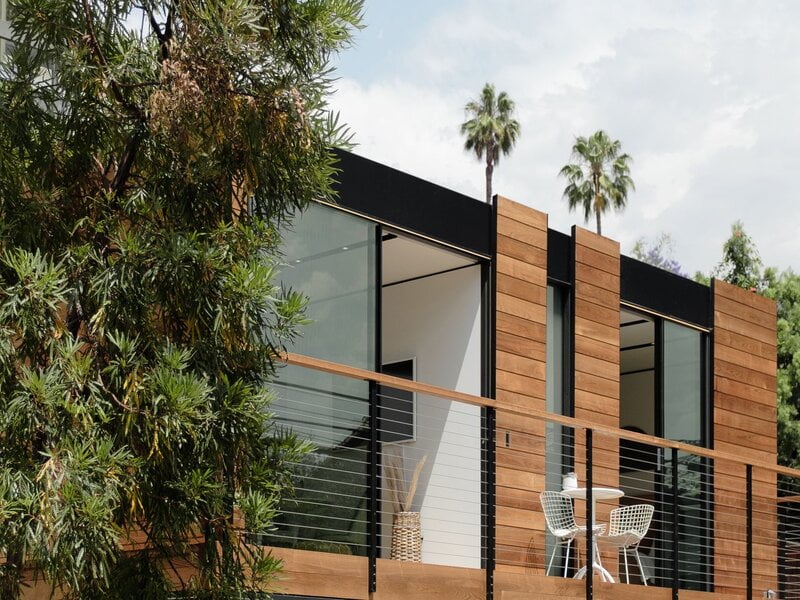 The exterior of the building features a unique combination of black and brown materials, creating a visually captivating and distinctive appearance. 