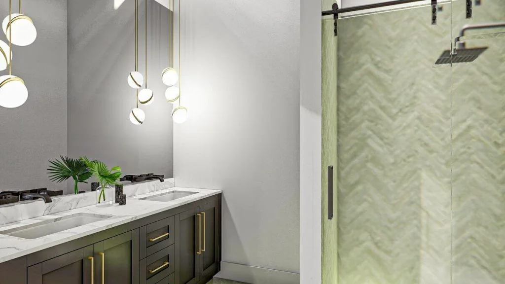 View of a bathroom with a shower and two sinks with a small cabinet and hanging lights.