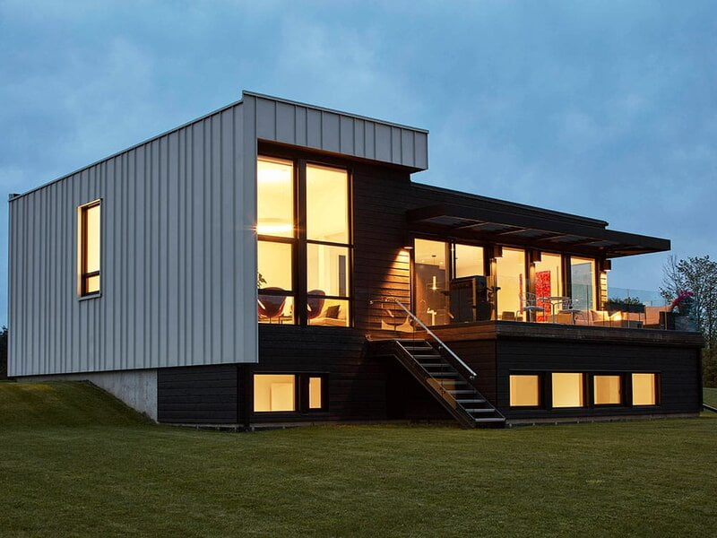  A striking two-story barn painted in contrasting white and black hues. 