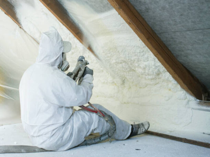 A close-up view of a spray foam insulation application in progress. 
