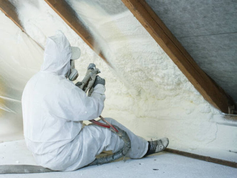 A close-up view of a spray foam insulation application in progress.