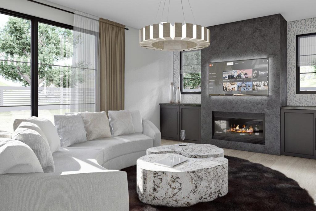View of the family room with a white c-couch shape and a marble table with a flat-screen tv and a hanging light.
