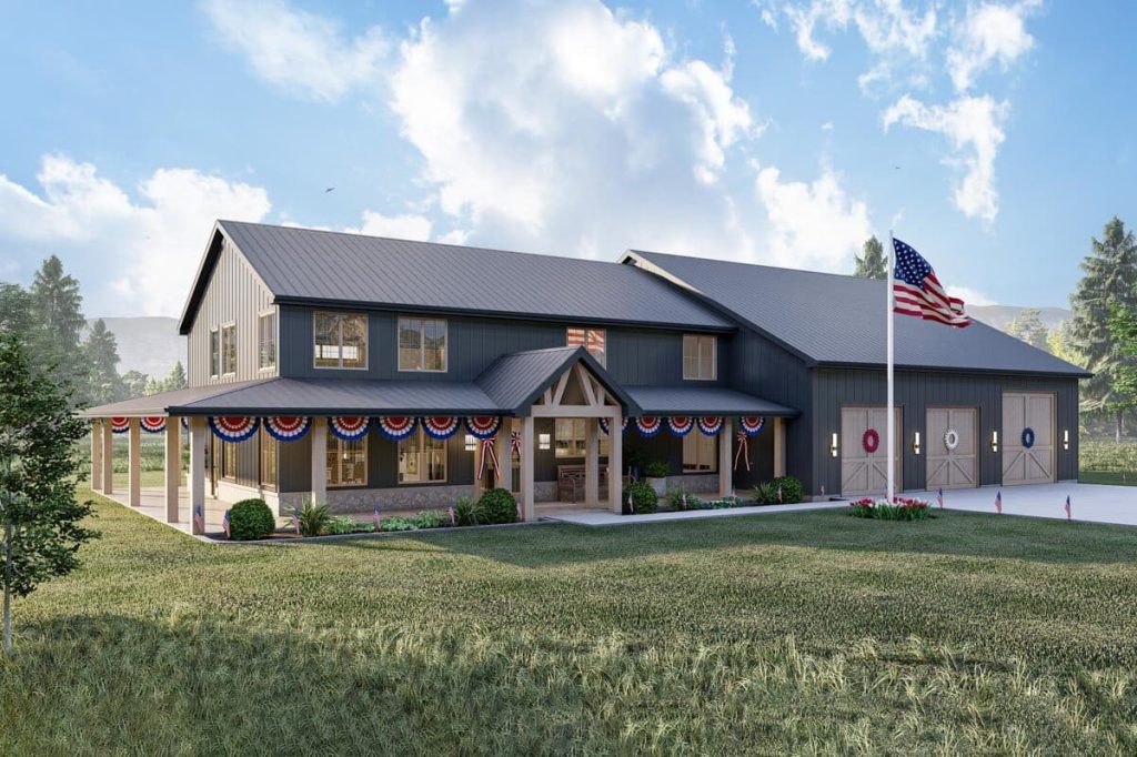 An angled rear left view of the Exquisite 4-bed Barndominium, a beautiful house with a unique blend of barn and modern architectural styles. The exterior features a prominent American flag proudly displayed on the front of the house, symbolizing patriotism and a sense of national pride.