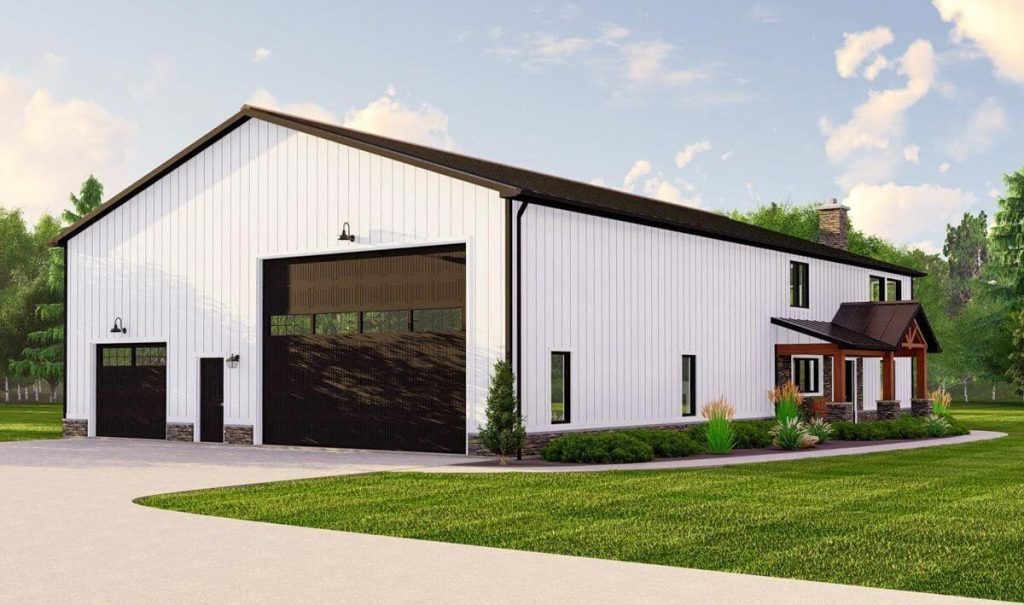 Side perspective of a sturdy barndominium house, showcasing its metallic siding and distinctive architectural features. The image prominently features the large garage door and a glimpse of the welcoming entrance, hinting at the functional and stylish design of the home.