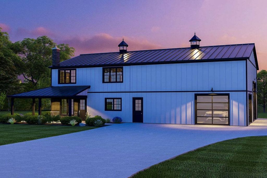 A captivating evening view of this stunning modern barndominium, illuminated by soft, ambient lighting that enhances its contemporary aesthetics. This serene and picturesque scene encapsulates the timeless allure of this architectural masterpiece under the twilight sky.