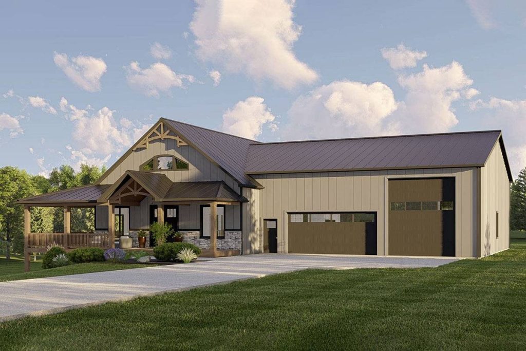 A picturesque front view of the Barndominium that artfully displays its welcoming wrap-around porch, complemented by an adjacent car garage and a spacious, accommodating driveway that stretches wide. This comprehensive perspective highlights the harmonious blend of aesthetics and practicality in this barndominium's architectural design.