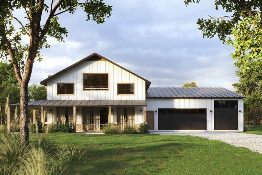 A captivating front view of the chic 3-bedroom modern barndominium, spotlighting the main entrance, the inviting wrap-around porch, and the conveniently located car garage on the side. This perspective provides a comprehensive look at the key architectural features that define the elegance and practicality of this structure.