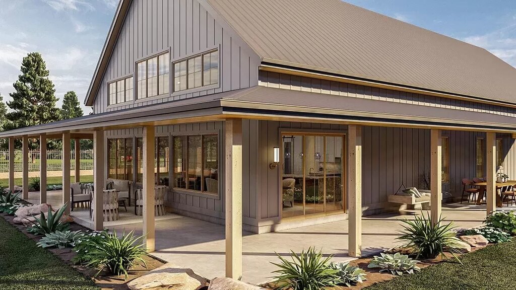 A close-up view of the barndominium showcasing the wrap-around patio at a different angle.