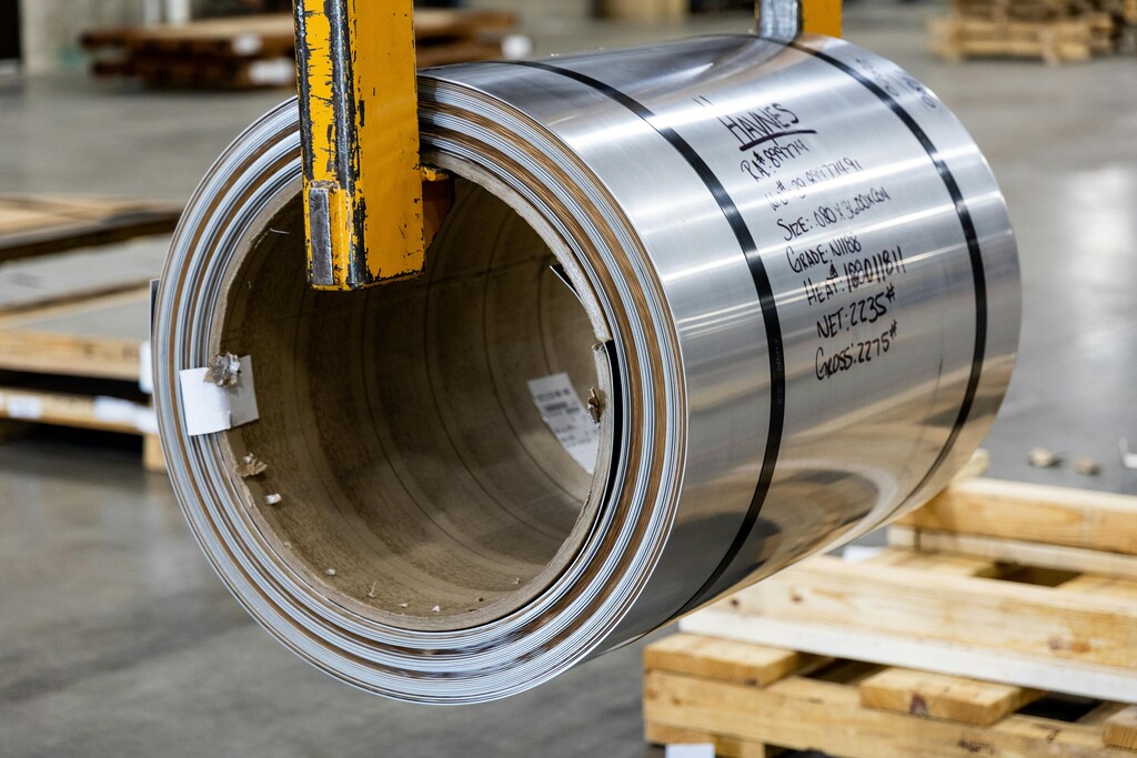 A steel roll being lifted for storage in a warehouse