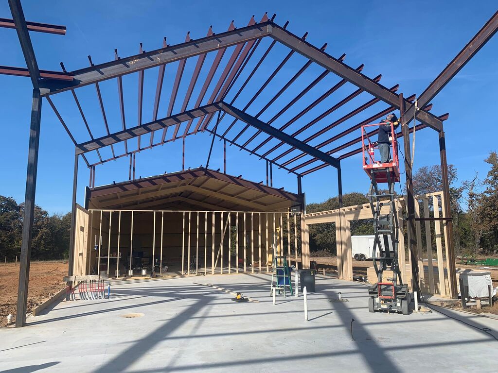 The large steel frame structure of a barndominium under construction. 